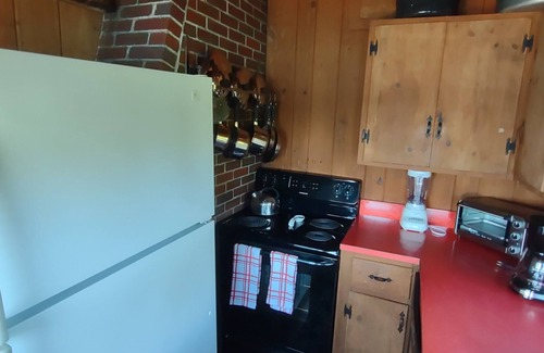 South Bristol Cabin | Cozy waterfront log cottage with huge outdoor living area.