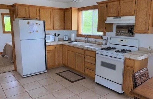 Cody Apartment | Creek Side Cabin #1 in the Wapiti Valley and steps from Trout Creek