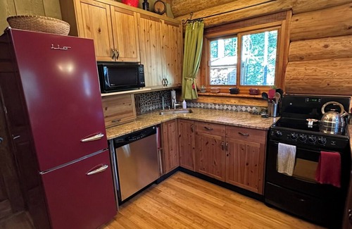 Crawford Bay Cabin | Creek side cabin in the woods with wood stove and deck - pet friendly!