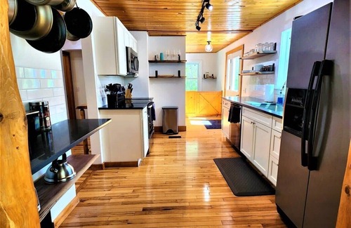 Traverse City Cottage | Creekside Hot Tub|Walk to Beach|Uniquely Northern