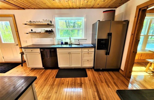 Traverse City Cottage | Creekside Hot Tub|Walk to Beach|Uniquely Northern