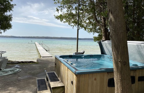 Lake Township House | Crystal Lake Waterfront Cottage with Private Dock, Yard, & Hot Tub