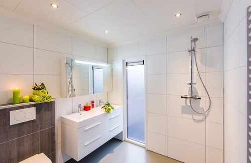 De Bult Villa | Designed home with bedstead, surrounded by forest