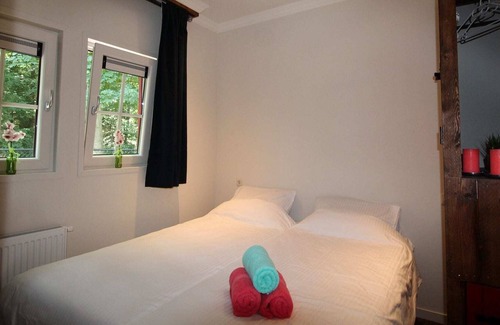 De Bult Villa | Designed home with bedstead surrounded by forest