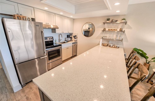 Vanderbilt Beach Condo | Designer Condo! Walk to the Beach! Bay Views! Rooftop Pool! Fully Renovated!
