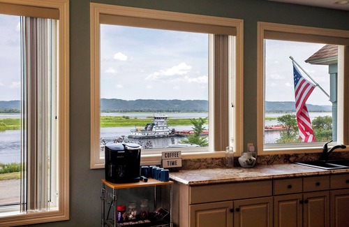 Minneiska House | Discover ‘Riverview Radiance,' a 5BR Minneiska marvel where the Mississippi meets modern luxury. Perfect for large groups, this home boasts a fully-equipped kitchen, sprawling views, and a suite of entertainment options. Revel in comfort with plush
