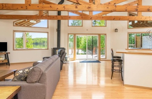 Houston House | Dog-friendly lakefront cabin with private hot tub & inflatable kayaks