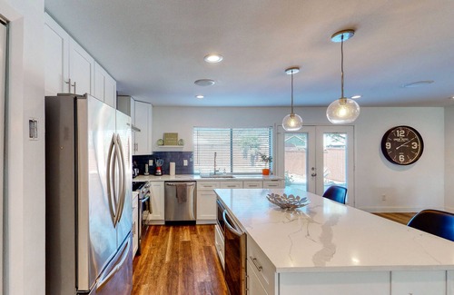 The Colony House | Dog-friendly remodeled home with full kitchen, outdoor pool, & arcade games