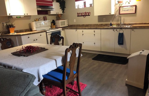 Township of Woolwich Apartment | Doggy heaven. Large fenced yard , beautiful gardens, guest patio and firepit.