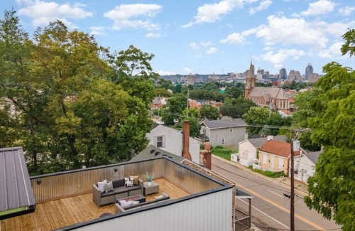 Covington House | Downtown skyline vista featuring giant rooftop deck & wet bar with a city view