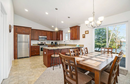 Empire House | Enchanting lakefront home with firepit, patio, grill & washer/dryer