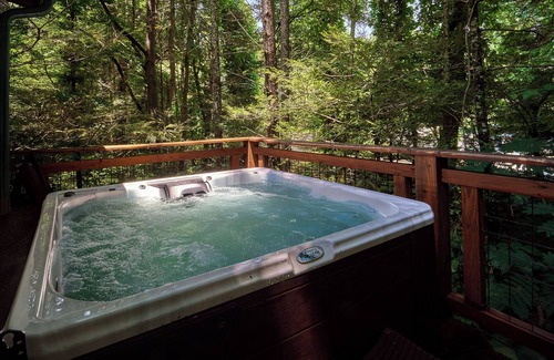 Gatlinburg - Pigeon Forge Cabin | Enjoy the creek, fire pit, hot tub and swing set- sleeps 14 guests