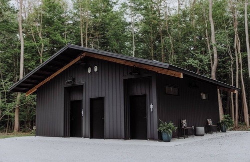 Fennville RV Rental | Enjoy the simplicity and elegance of a cozy bedroom in the woods.
