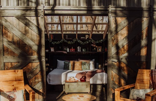 Fennville RV Rental | Enjoy the simplicity and elegance of a cozy bedroom in the woods.