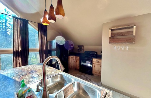 Island Park House | Enjoy the spacious vaulted ceilings with a full kitchen and open concept living!