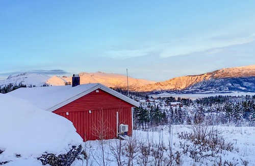Steigen House | Enjoy the view of mountains and forests in this cozy vacation home.