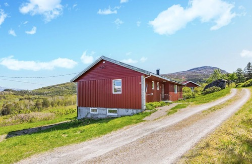 Steigen House | Enjoy the view of mountains and forests in this cozy vacation home.
