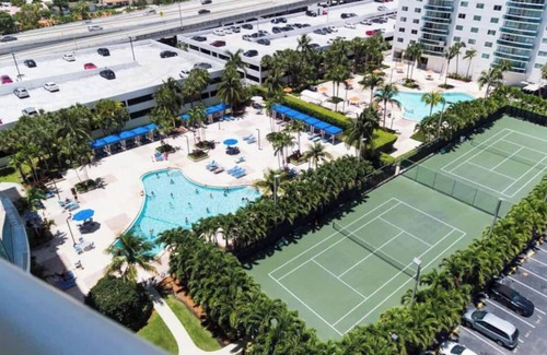 Aventura Condo | Entire condominium with a pool view, steps from the beach