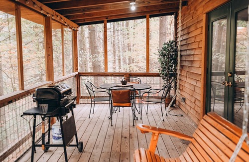 Carbon Hill Cabin | Evergreen Hideaway is a cabin nestled under tall pines.