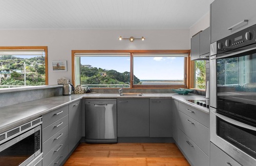 Mangawhai Heads House | Fairport House - Sunny holiday home with large decks, lovely views and a short stroll to the estuary