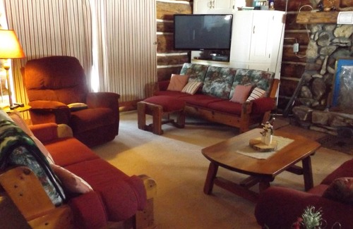 Perronville Cabin | Family friendly comfy log lodge and pond.