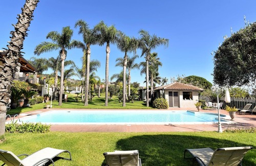 Macchia House | Fantastic vacation home with paradisiacal garden at the foot of the volcano Etna.