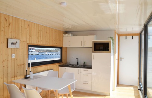 Blankaholm Boat Rental | Floating house, unobstructed view of the beautiful water with boat, Blankaholm Sweden