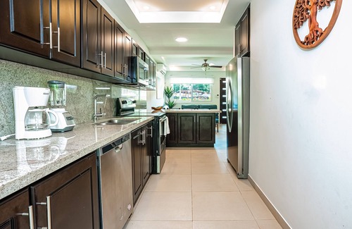 Villarreal Condo | Gated resort condo with on-site pool, outdoor areas, private patio, & W/D