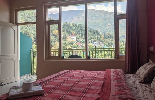 Dharamshala Bed & Breakfast | Golden View BnB Mcleodganj nRoom with private balcony facing mountain view.