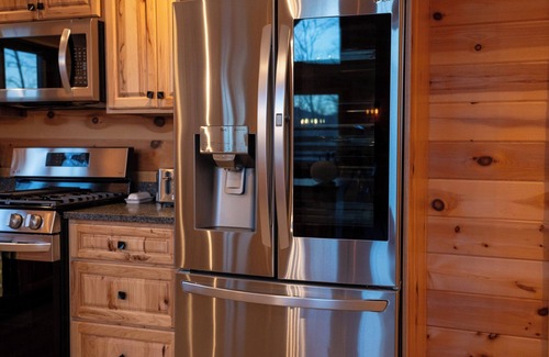 Carrabassett Valley Cabin | Gorgeous dog-friendly cabin with great view, deck, hot tub, & gas fireplace