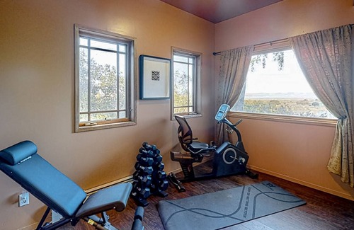 Black Point-Green Point House | Gorgeous river view home with wood stove, sauna, patio, fitness room, & kitchen