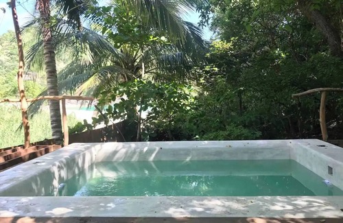 Arroyo Cruz House | Great room with deck pool in front of perfect bay