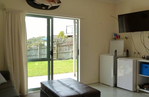 Opito Bay House | Great views, great family bach, super close to the beach and a spa pool!