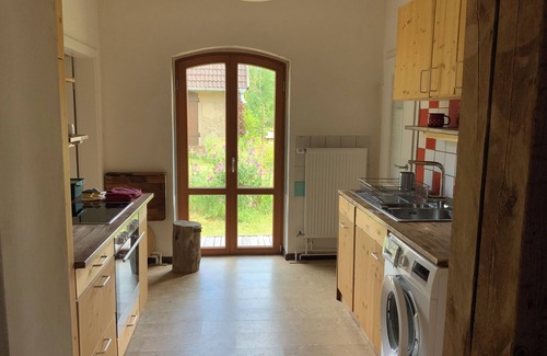 Karow Apartment | Historic house under lime trees with natural garden. Family-friendly.