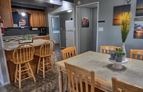 Eddyville House | Holiday House (Sleeps 1-12) - Offer a 4-bedroom, 2-bath unit with 1 queen, 3 full, 4 twin beds, and a pull-out sofa.