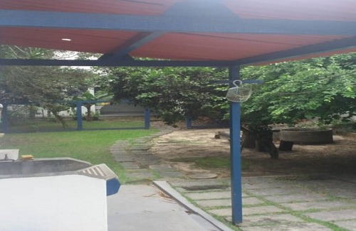 Balneario Remanso House | home Beach Center, wooded and grassy yard with fruit trees.