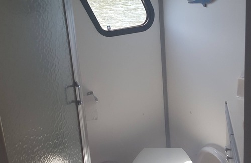 Coopersville Boat Rental | Houseboat on Grand River on private wooded lot