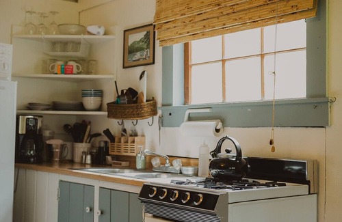 Seeley Lake Cabin | Huckleberry Cabin at Tamaracks Resort with a lake facing furnished screen porch.