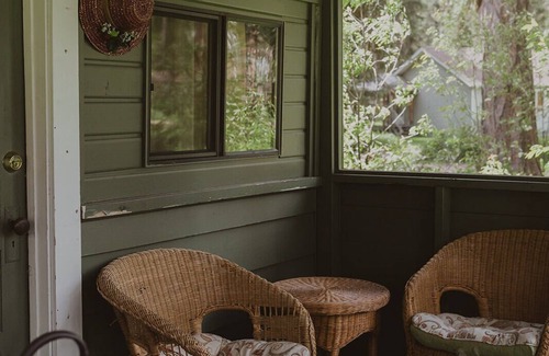 Seeley Lake Cabin | Huckleberry Cabin at Tamaracks Resort with a lake facing furnished screen porch.