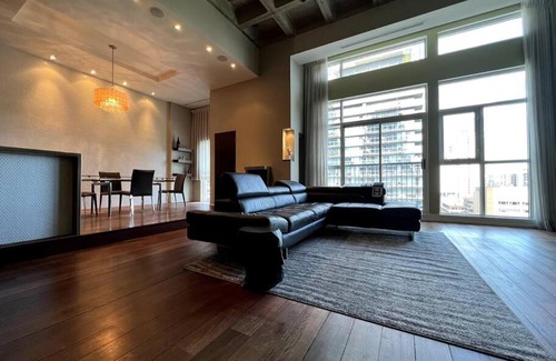 Church and Wellesley Apartment | Huge 2 Storey Loft W designer furniture and art