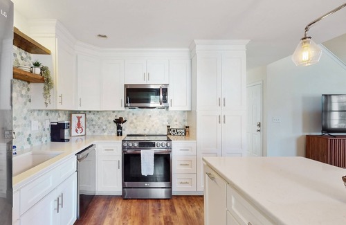 Hampstead House | Idyllic retreat with surfboards, hot tub, open layout, & firepit - dog-friendly