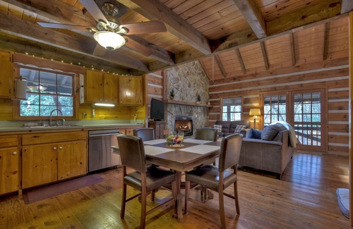 Dial Cabin | Indulge in "Just One More Night", a pet-friendly creekfront retreat boasting a spacious outdoor deck, hot tub, firepit, and WiFi