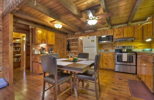 Dial Cabin | Indulge in "Just One More Night", a pet-friendly creekfront retreat boasting a spacious outdoor deck, hot tub, firepit, and WiFi