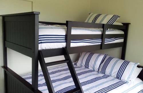 Raglan House | Karoro the beach front bach with views to die for!