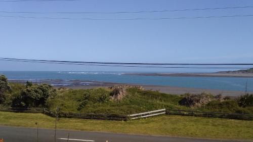 Raglan House | Karoro the beach front bach with views to die for!