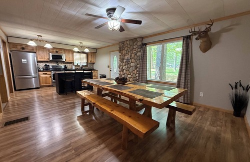 Prudenville Cabin | Knotty by Nature! Firepit and Parking! Less than a mile to trails and the lake!