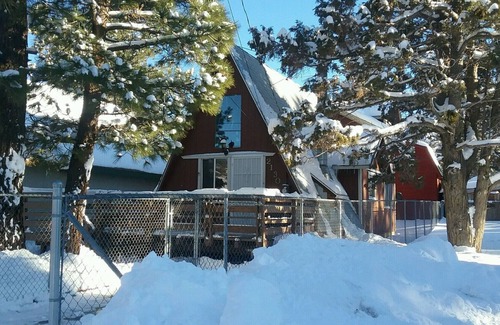 Woodlands Ski Chalet | Knotty Pine Chalet has a huge front deck and fully fenced yard .