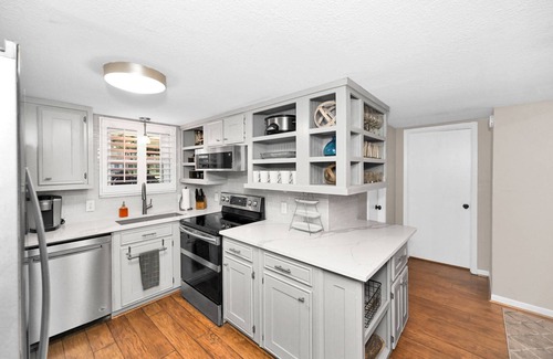 Leisure Land House | Lady of the Lake! Lake Front Property with Boathouse, Pet Friendly, Hot Tub, & Outdoor Sitting Area
