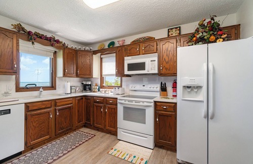 Au Gres House | Lake Huron Beach Retreat has 3 bedrooms and 2 full baths with a sandy beach!