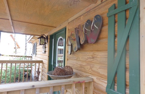 Mount Ida Cottage | Lake view two bedroom, two bath log-sided cottage with private hot tub overlooking Lake Ouachita. by RedAwning